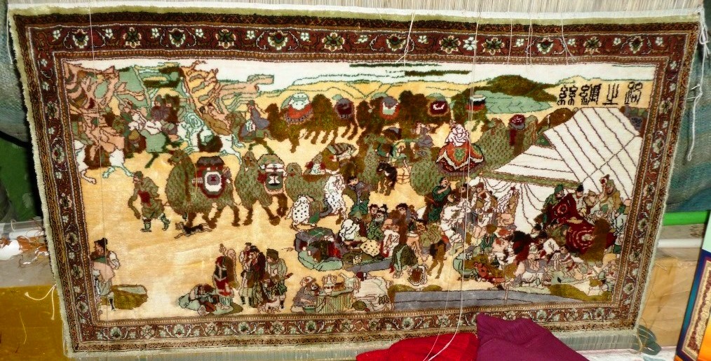 A camel caravan traversing an arid landscape along the ancient Silk Road route