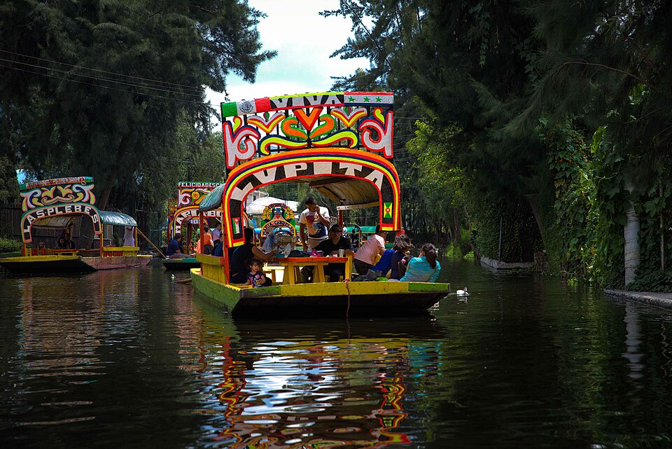 Trajineras (gondola-style boats) navigating the chinampas canals of Xochimilco, Mexico City