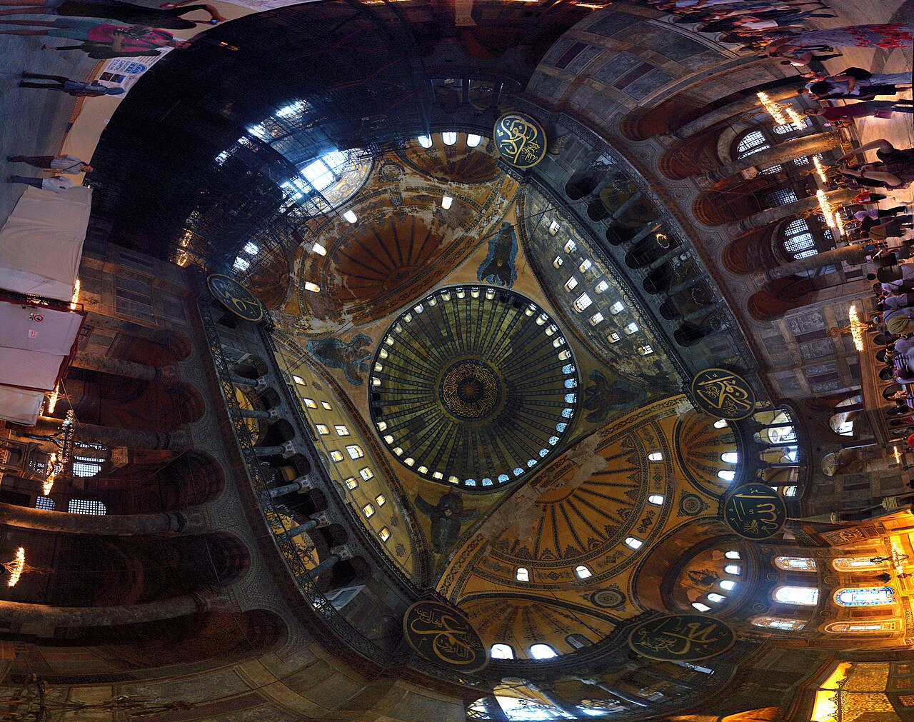 Interior of the Hagia Sophia showing its vast dome, semi-domes, and gold mosaics