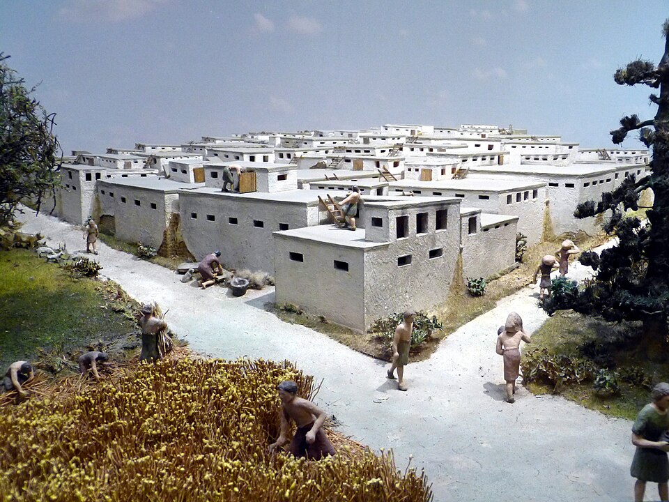 Scale model of the Neolithic settlement of Catalhoyuk showing densely packed mud-brick houses with roof entry points and no ground-level streets