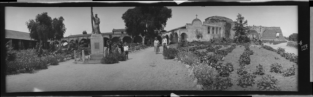 A whitewashed Spanish colonial mission building with a bell tower and arched entrance