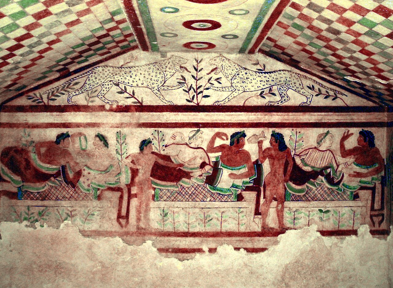 A colourful Etruscan tomb fresco depicting figures at a banquet scene