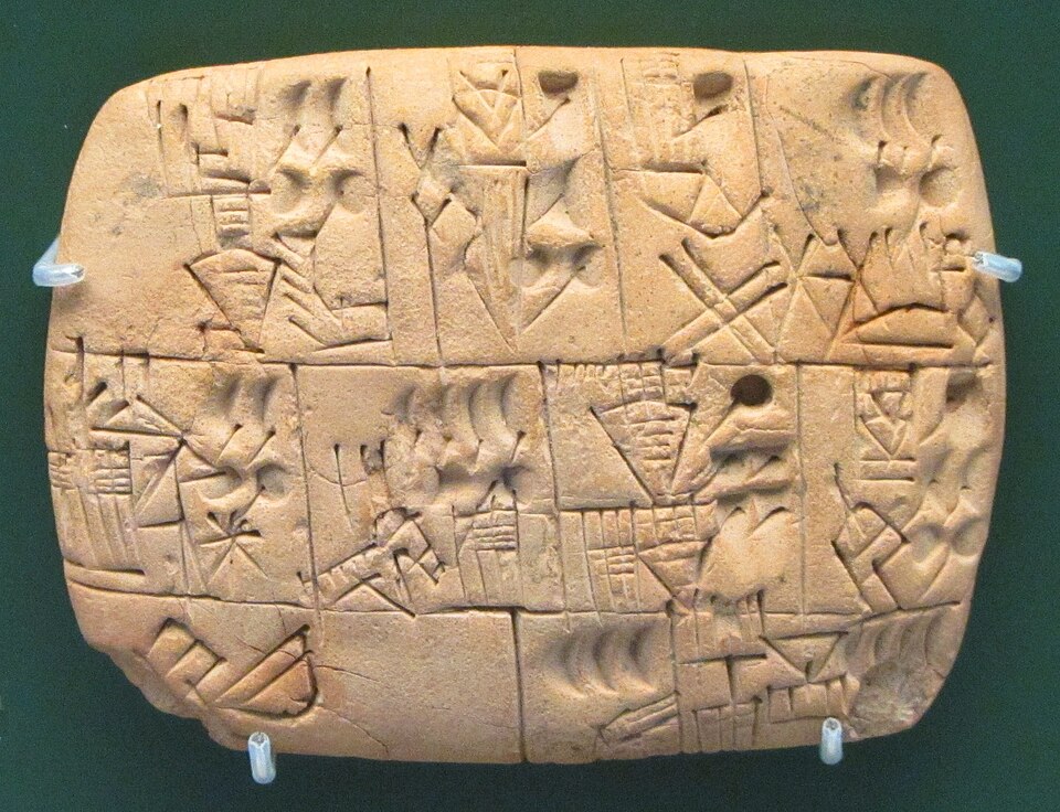 A small clay tablet impressed with proto-cuneiform signs recording the allocation of beer, dated 3100-3000 BCE, from southern Iraq, British Museum