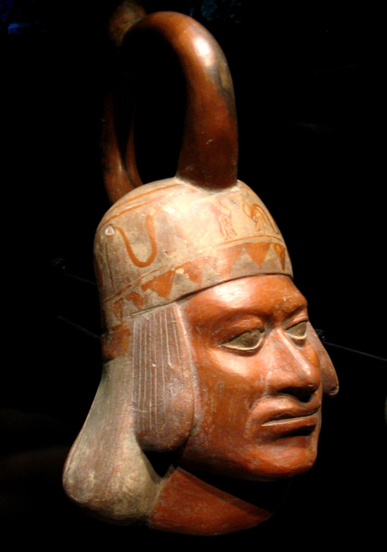 A realistic ceramic portrait vessel from the Moche civilization depicting a human face