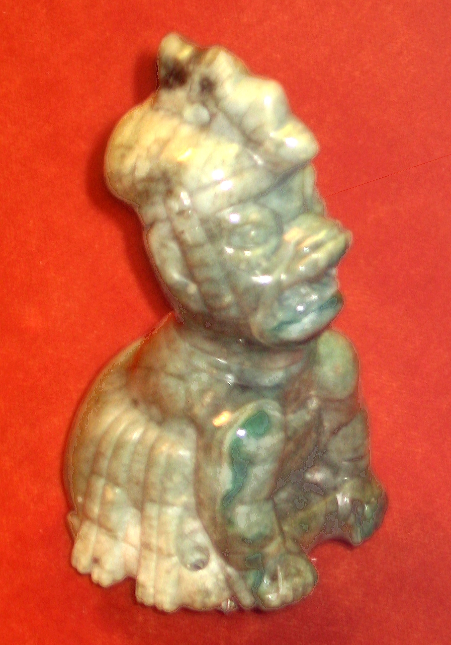 Small jade figurine of a seated Olmec were-jaguar with almond-shaped eyes, cleft head, and snarling mouth, American Museum of Natural History