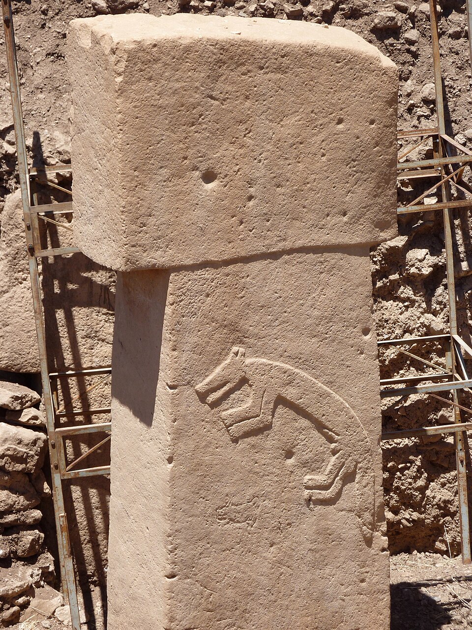 T-shaped limestone pillar at Gobekli Tepe with carved animal reliefs