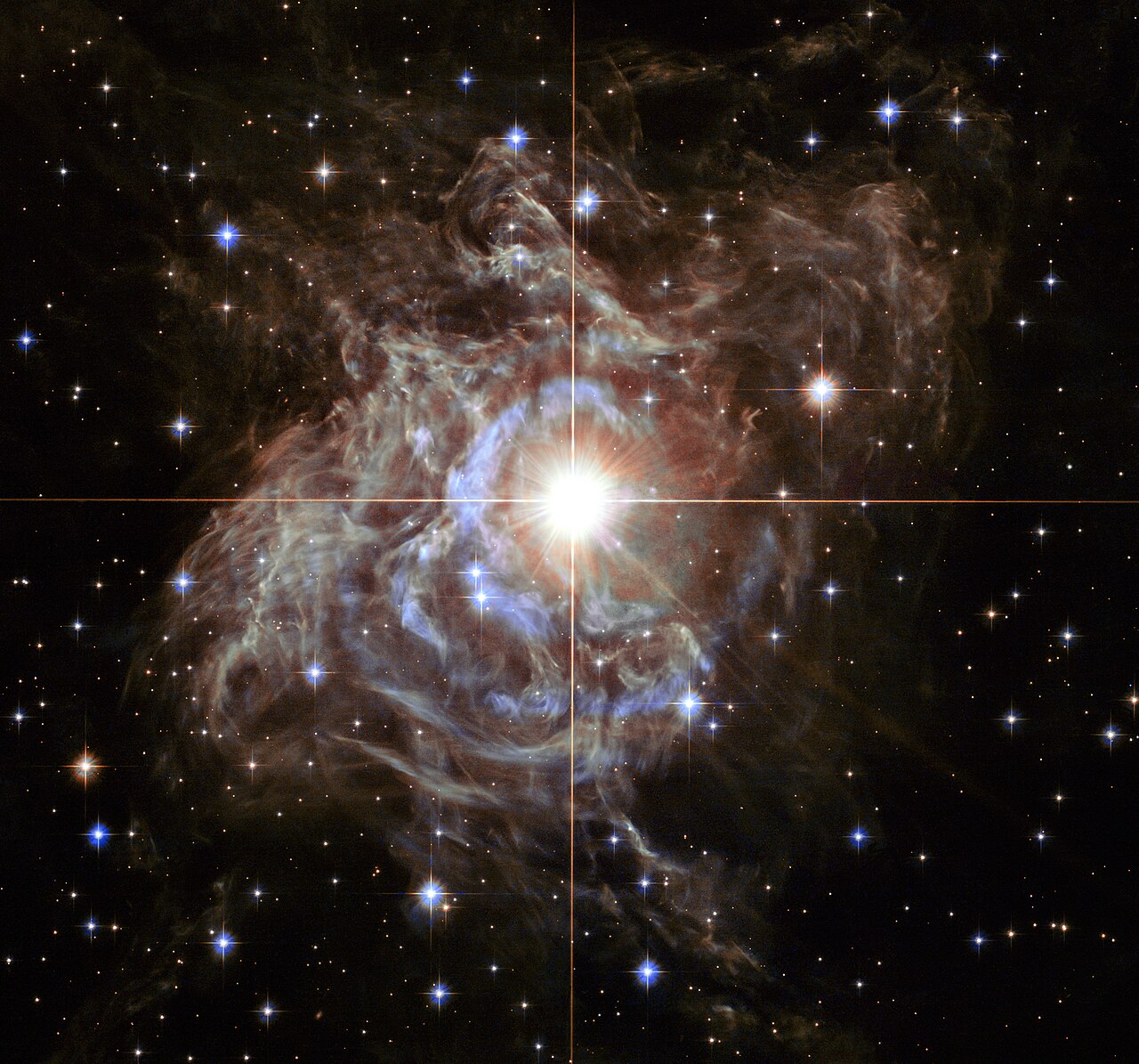 This festive NASA Hubble Space Telescope image resembles a holiday wreath made of sparkling lights. The bright southern hemisphere star RS Puppis, at 