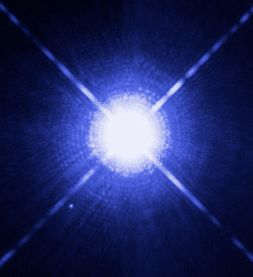 Hubble Space Telescope image of Sirius A, the brightest star in the night sky, with its faint white dwarf companion Sirius B visible as a small dot to the lower left