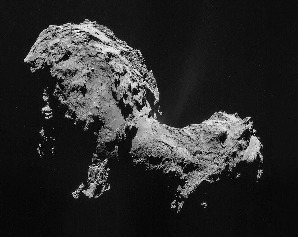 The bilobed nucleus of comet 67P/Churyumov-Gerasimenko imaged by Rosetta's NavCam, showing the dark, dust-covered surface, jagged cliffs, and smooth plains