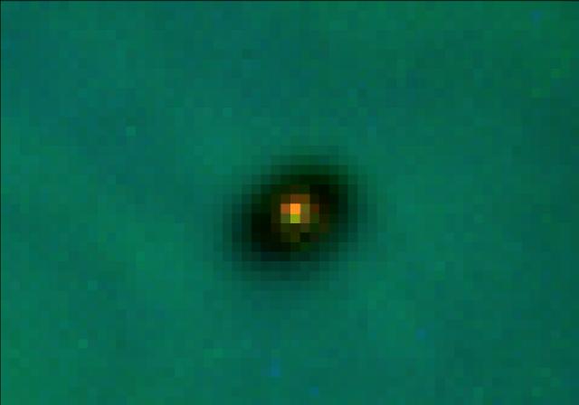 Hubble Space Telescope image of a young star surrounded by a dark protoplanetary disk silhouetted against the Orion Nebula