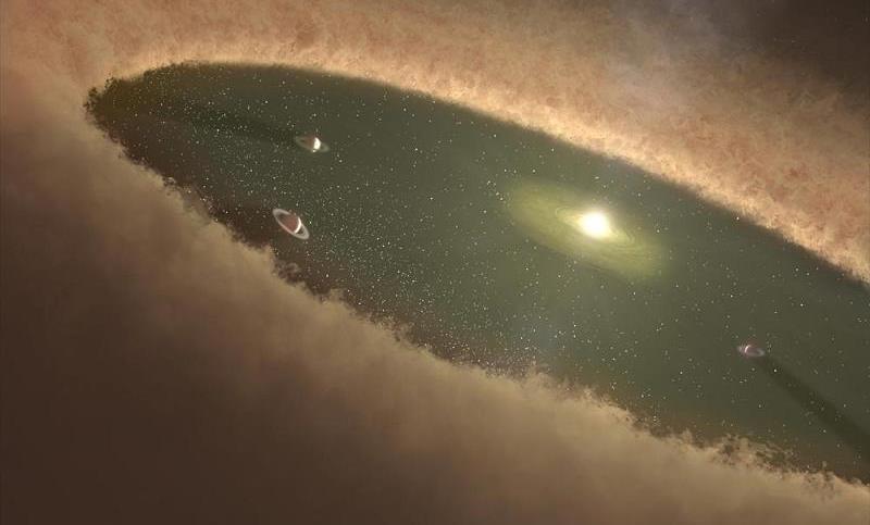 Artist's concept of a protoplanetary disk around a young star, showing a gap in the disk believed to be occupied by forming gas giant planets