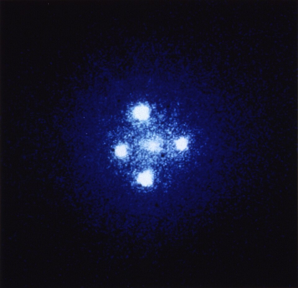 Hubble Space Telescope image of the Einstein Cross, a gravitationally lensed quasar split into four images by a foreground galaxy