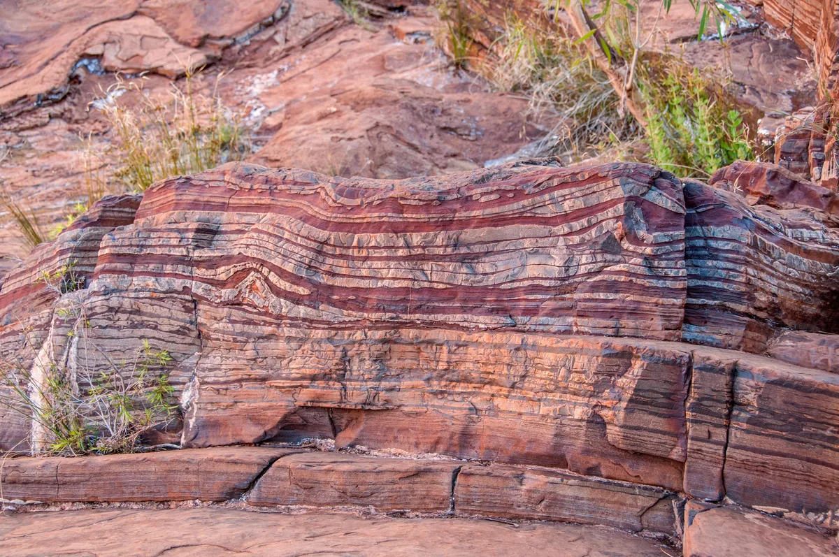 Banded iron formation outcrop at Dales Gorge in the Hamersley Range, Western Australia, showing alternating layers of iron-rich and silica-rich bands