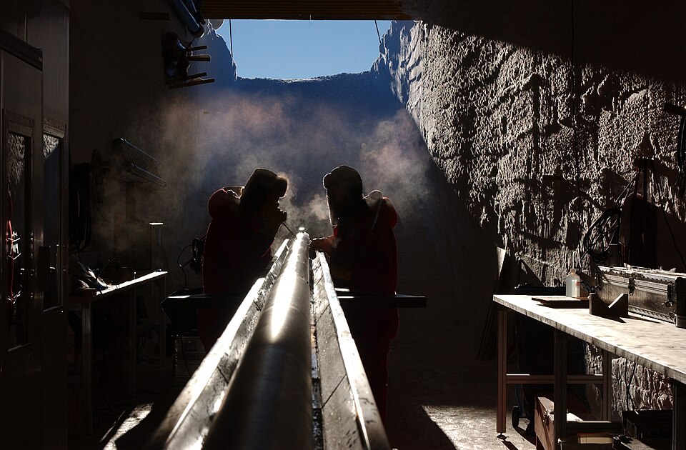 Scientists preparing the EPICA ice core drill for deployment at Kohnen Station, Antarctica