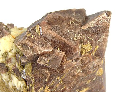 A transparent reddish-brown zircon crystal showing typical tetragonal form