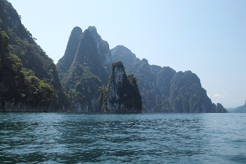 Karst limestone towers rising from Cheow Lan Lake, Thailand, sculpted by chemical weathering and dissolution of carbonate rock