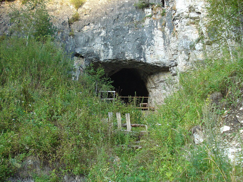 Entrance to Denisova Cave in the Altai Mountains of Siberia, where fragmentary fossils yielded the ancient DNA that revealed the Denisovan lineage