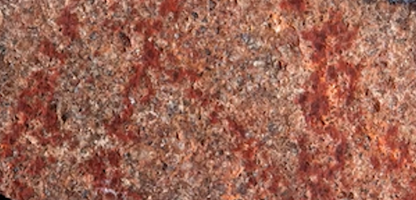 Photograph of the silcrete flake L13 from Blombos Cave bearing a cross-hatched red ochre drawing.